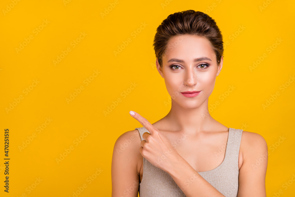 Portrait of attractive shine girl demonstrating copy empty blank space isolated over bright yellow color background Portrait of attractive shine girl demonstrating copy empty blank space isolated over bright yellow color background