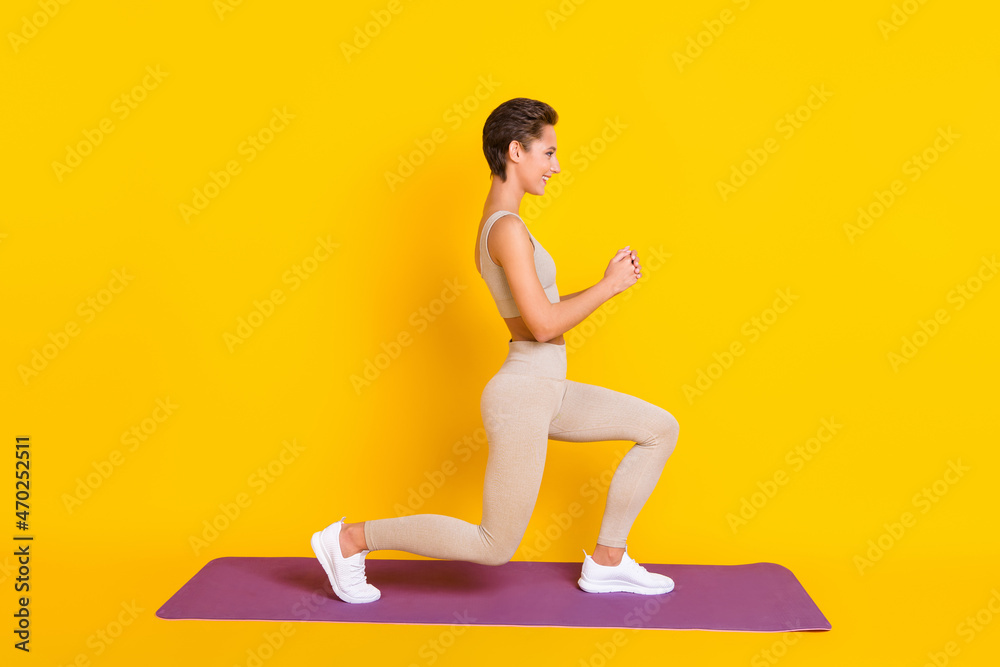 Profile photo of charming lady do stretch exercise wear cropped top leggings isolated yellow color background