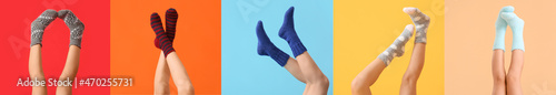 Legs of young woman in socks on color background photo