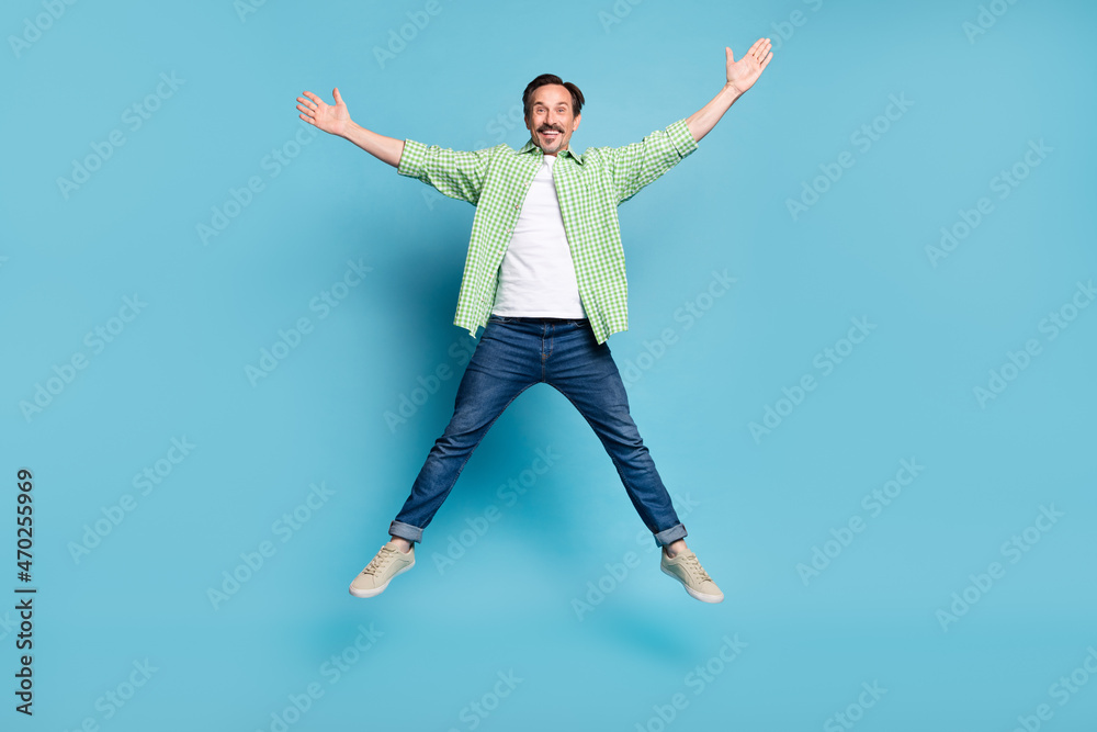 Full length body size view of attractive cheerful free man jumping having fun isolated over bright blue color background