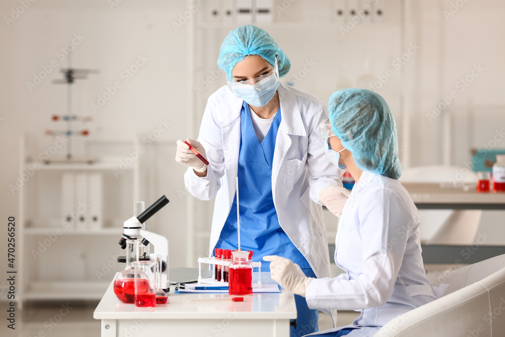 Scientists working with sample in laboratory Scientists working with sample in laboratory