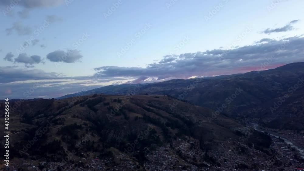 Aerial drone view of an orange sunset on the horizon covered by mountains in the Peruvian highlands of Huaraz Aerial drone view of an orange sunset on the horizon covered by mountains in the Peruvian highlands of Huaraz