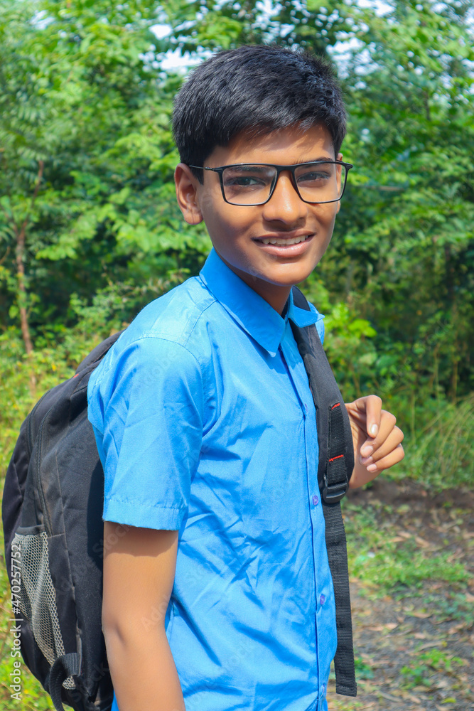 Cute little Indian / Asian school boy wearing spectacles