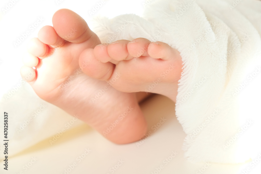 Blurred close up bare foot in the morning at home, fluffy blanket, relaxing Blurred close up bare foot in the morning at home, fluffy blanket, relaxing