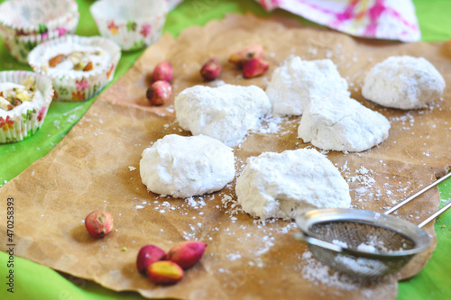 Manna and Salwa sweets are traditional Arabic sweets consisting of egg whites and pistachios on a baking sheet photo