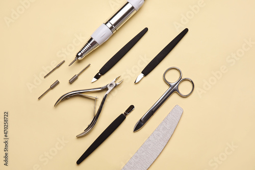 Manicure instruments on color background