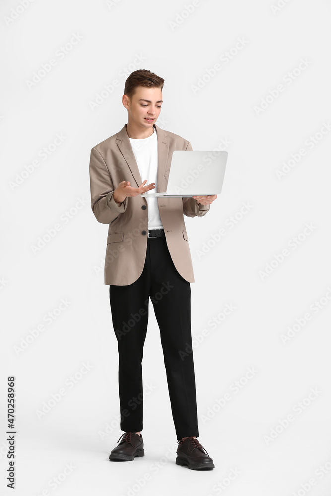 Teenage boy with laptop video chatting on white background Teenage boy with laptop video chatting on white background