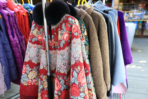 Demi-season coats on outdoor market