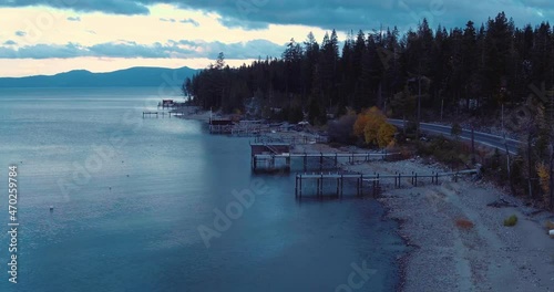 Aerial over shoreline and trees at Lake Tahoe