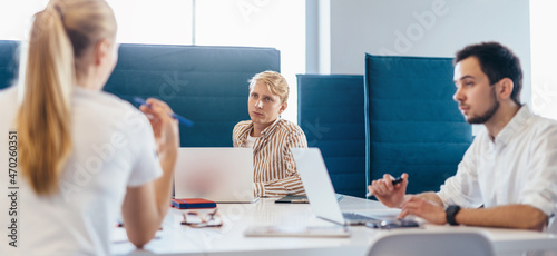 Photos Group of people confer at work sitting at desk