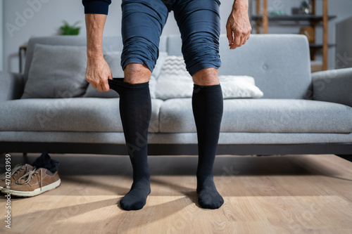 Man Putting On Medical Compression Stockings