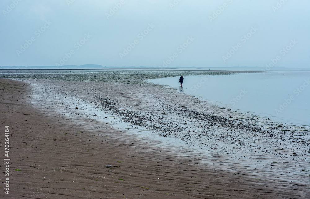 lonely man walking on a beach