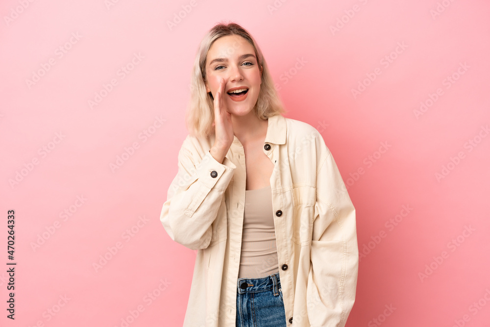 Young caucasian woman isolated on pink background shouting with mouth wide open Young caucasian woman isolated on pink background shouting with mouth wide open
