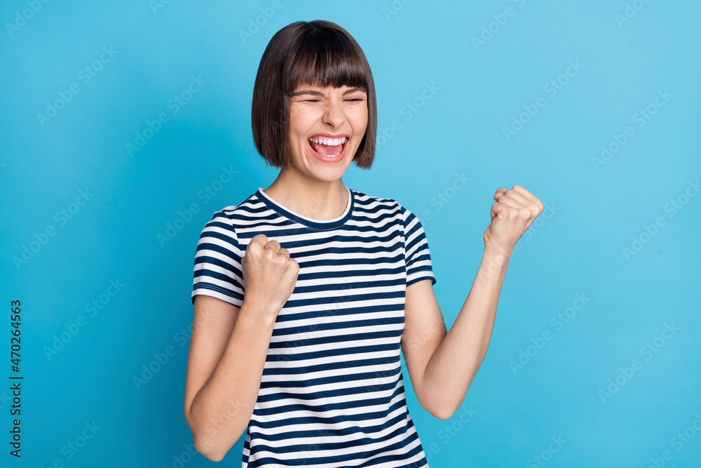 Photo of hooray brunette millennial lady yell wear striped t-shirt isolated on blue color background Photo of hooray brunette millennial lady yell wear striped t-shirt isolated on blue color background
