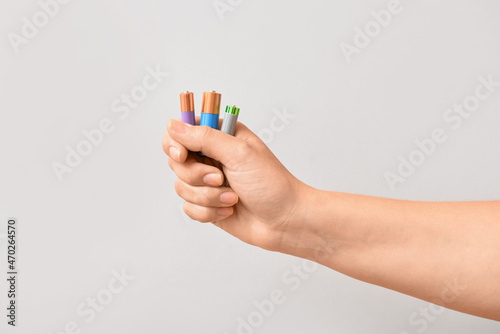 Woman holding alkaline batt...