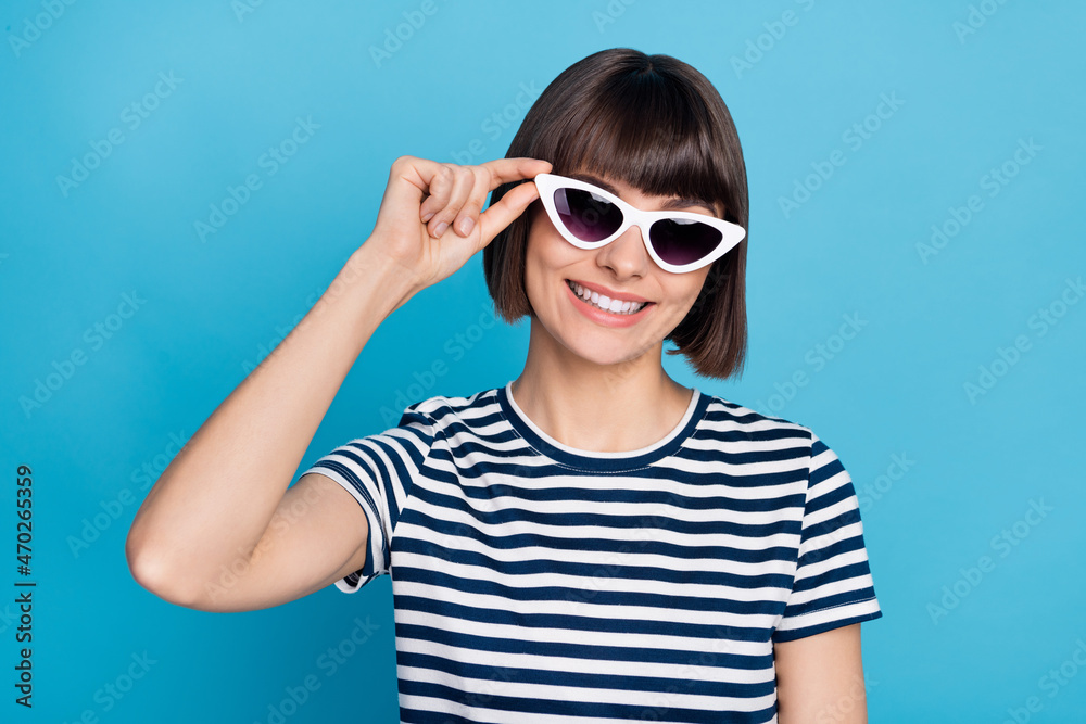 Photo of cool brunette millennial lady wear spectacles striped t-shirt isolated on blue background Photo of cool brunette millennial lady wear spectacles striped t-shirt isolated on blue background
