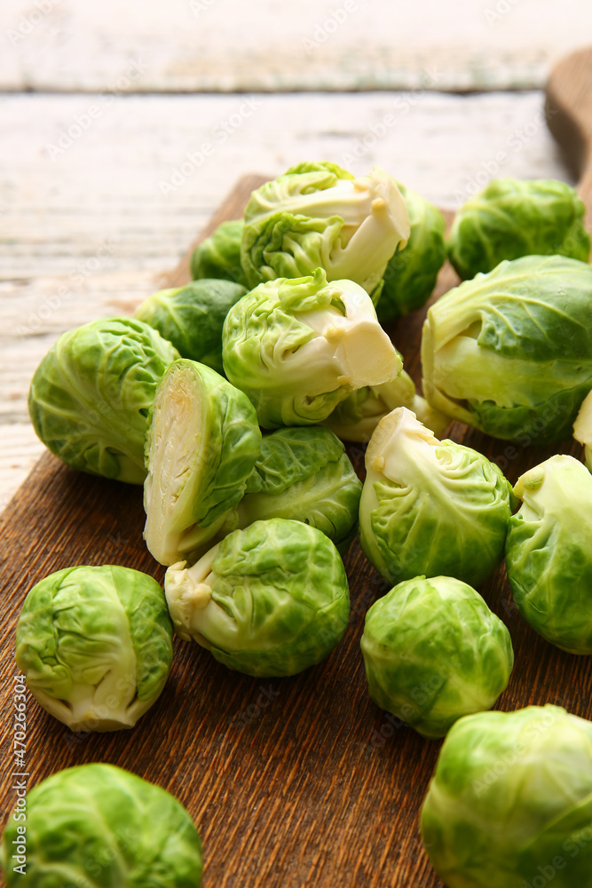 Board with fresh raw Brussels cabbage on table, closeup Board with fresh raw Brussels cabbage on table, closeup