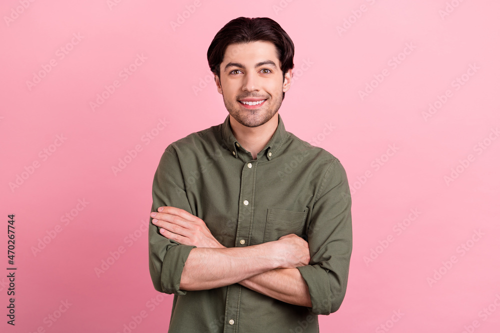 Photo of young happy positive confident man hands crossed good mood smile isolated on pastel pink color background Photo of young happy positive confident man hands crossed good mood smile isolated on pastel pink color background