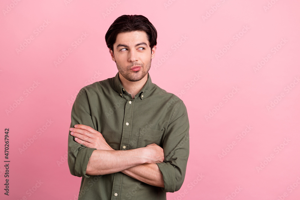 Photo of curious minded businessman crossed hands look empty space wear khaki shirt isolated pink color background Photo of curious minded businessman crossed hands look empty space wear khaki shirt isolated pink color background