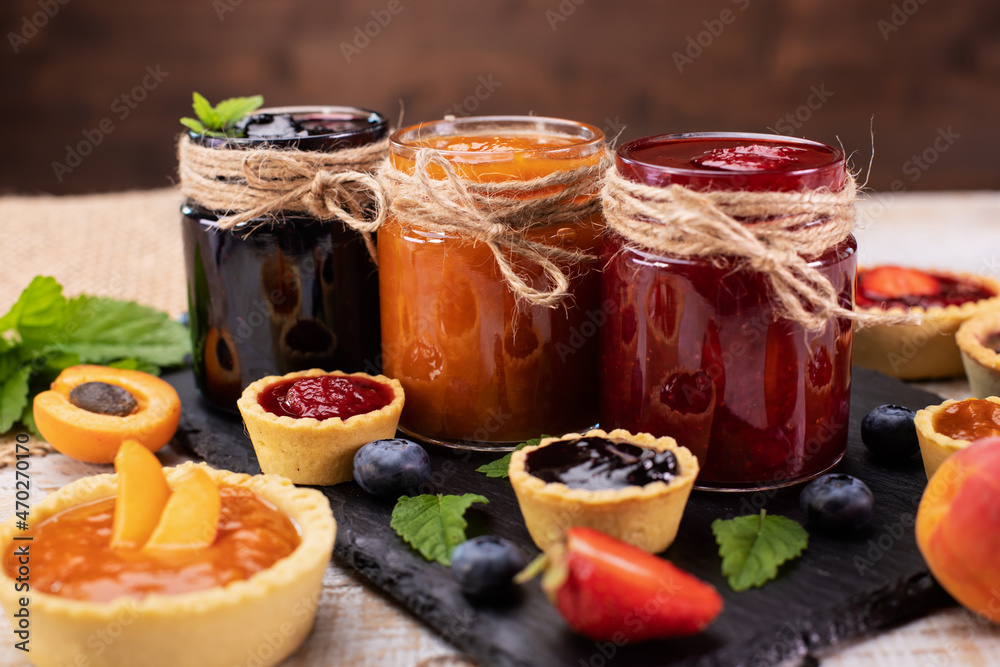 Jars with delicious summer fruits jam Jars with delicious summer fruits jam