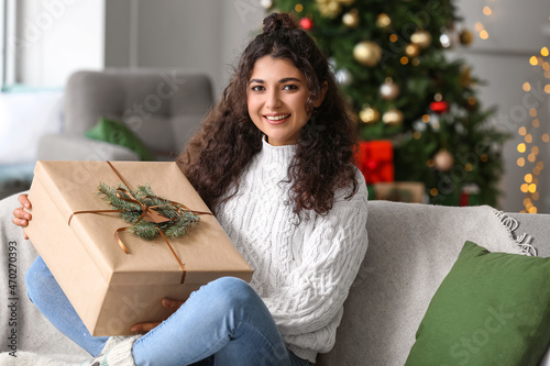 Smiling young woman holding...