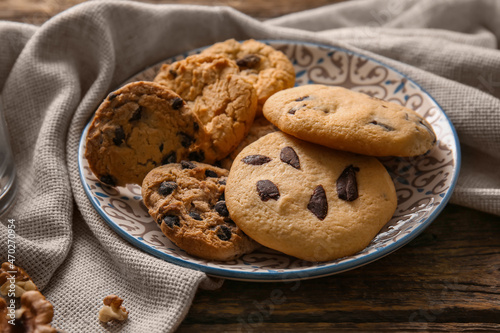 Plate with tasty homemade cookies on wooden background