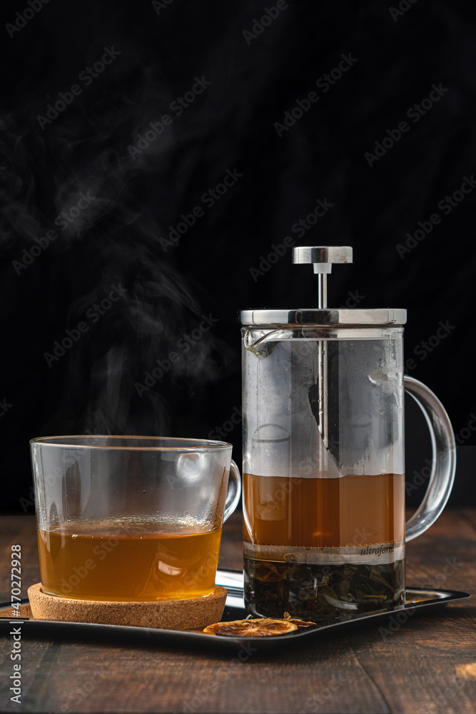 Hot winter tea served with a french press on a wooden floor. Hot winter tea served with a french press on a wooden floor.