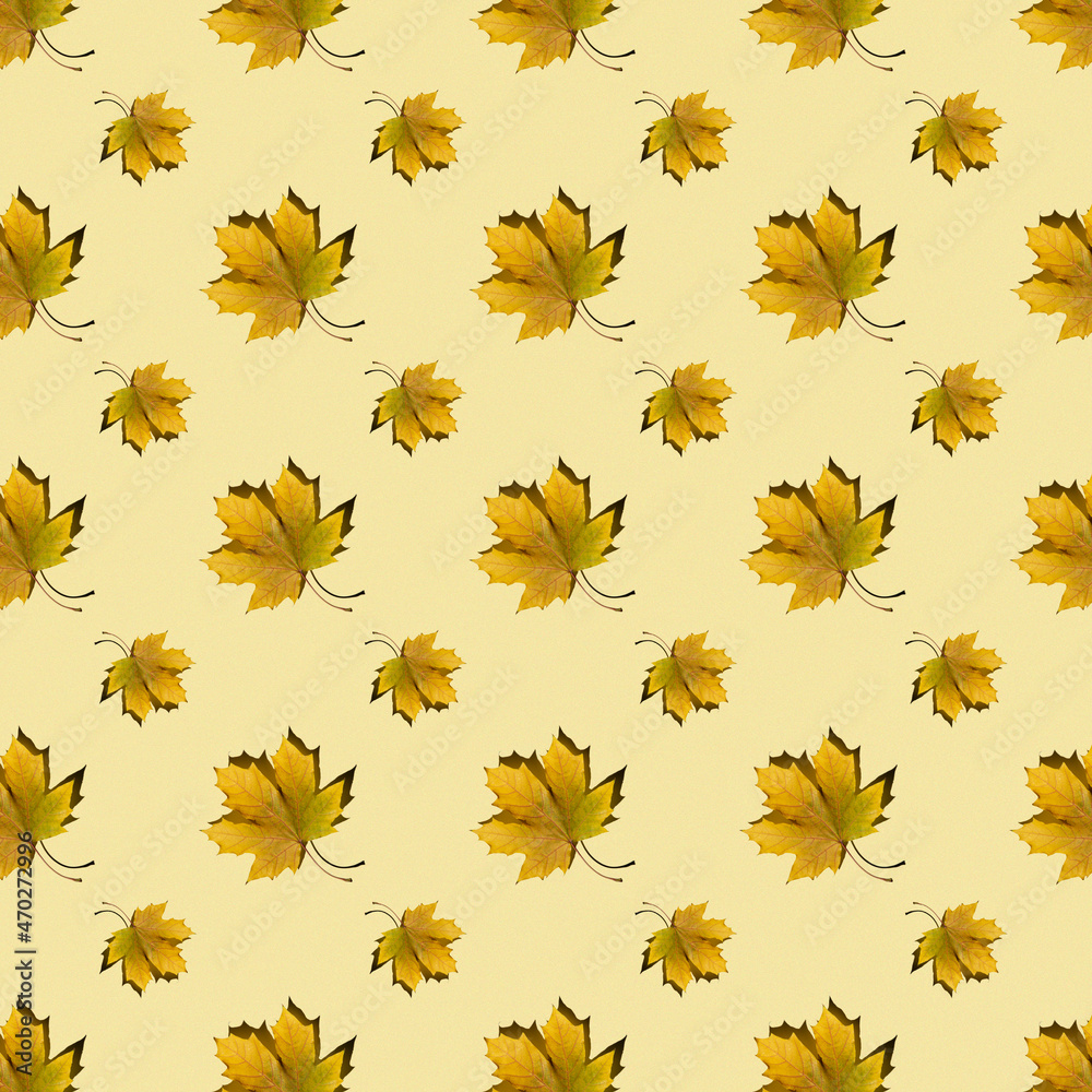 flat seamless pattern of maple leaves on a yellow background flat seamless pattern of maple leaves on a yellow background