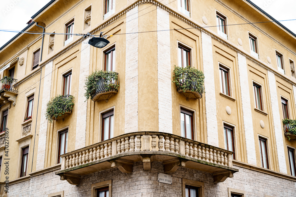 Old residential building with ivy-covered balconies in Bergamo. Italy
