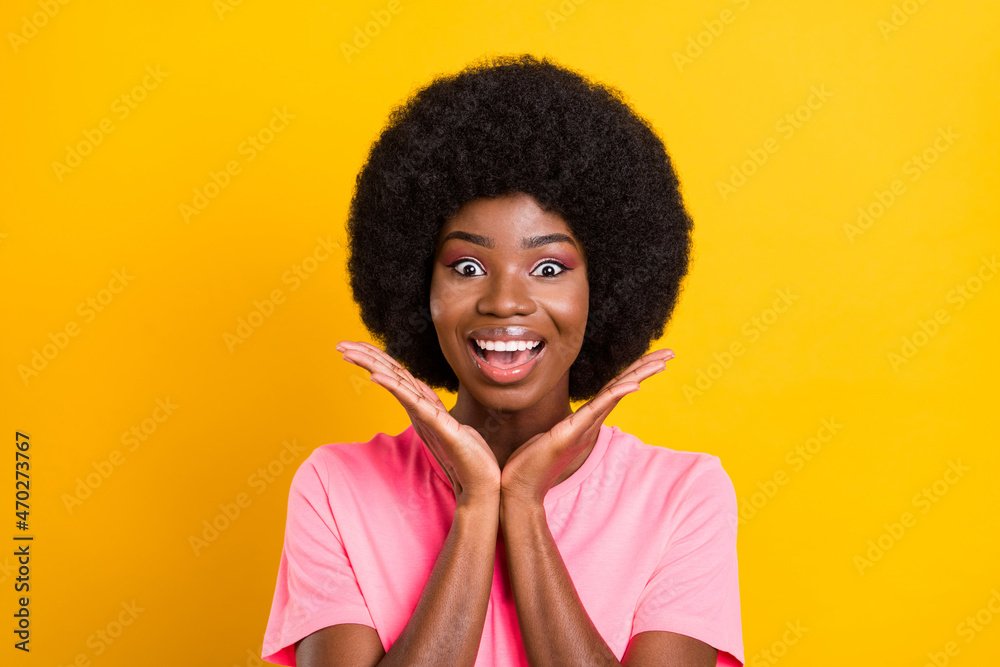 Photo of young excited black girl happy positive smile amazed surprised news isolated over yellow color background Photo of young excited black girl happy positive smile amazed surprised news isolated over yellow color background