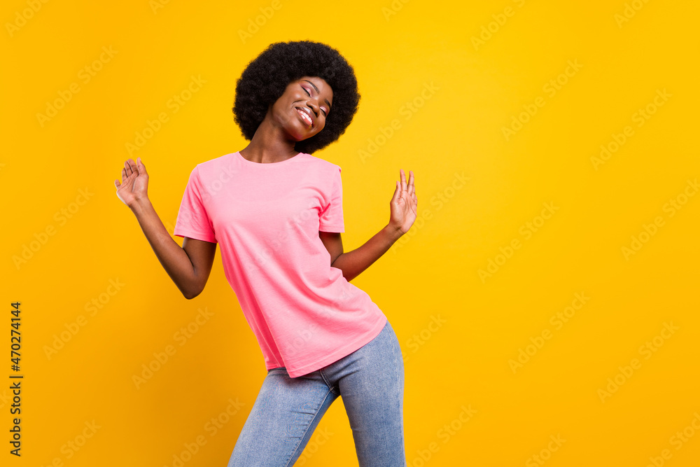 Photo of young cheerful black girl happy positive smile enjoy party dance isolated over yellow color background Photo of young cheerful black girl happy positive smile enjoy party dance isolated over yellow color background