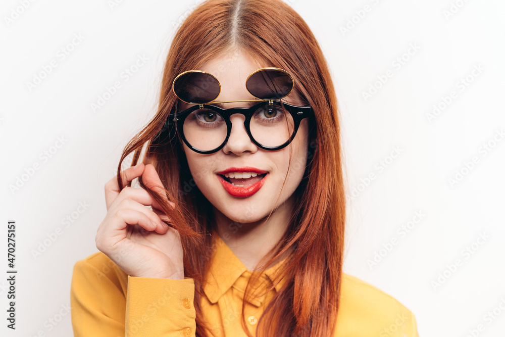 glamorous woman sunglasses red hair light background