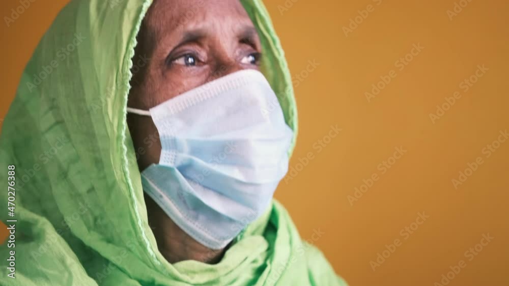 portrait of an old indian woman wearing a surgical mask portrait of an old indian woman wearing a surgical mask