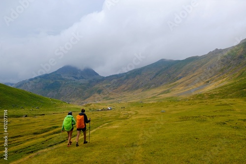Beautiful mountain view with walking people in misty valley, during hiking on peak Djeravica (Gjerovica) - the highest peak of Kosovo. Albanian Alps, Peaks of Balkans © Iwona
