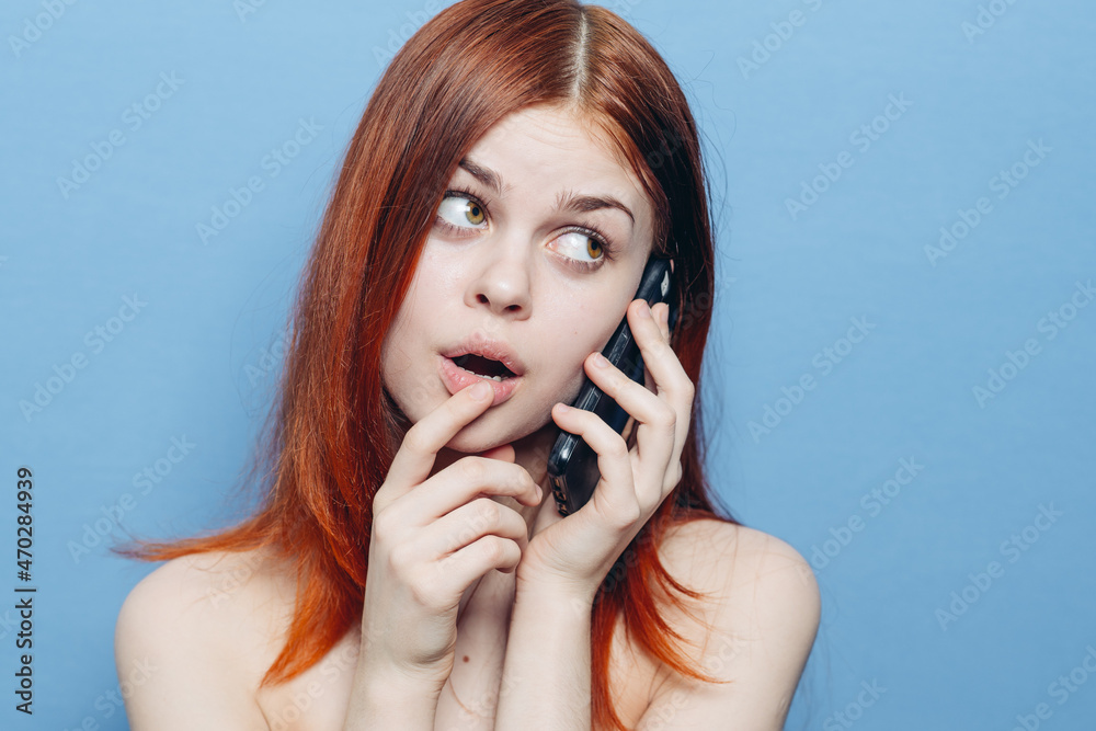 woman with red hair bare shoulders talking on the phone woman with red hair bare shoulders talking on the phone