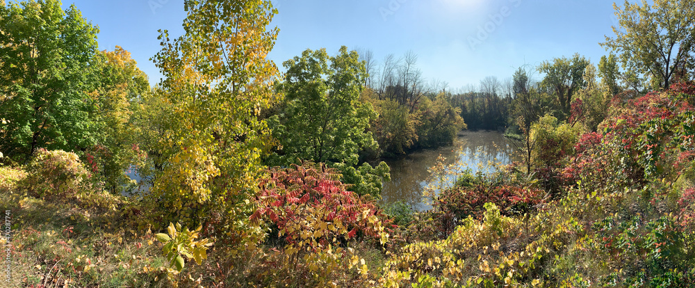 Naklejka premium Panoramic view in autumn along the Turtle River in Delson, Quebec