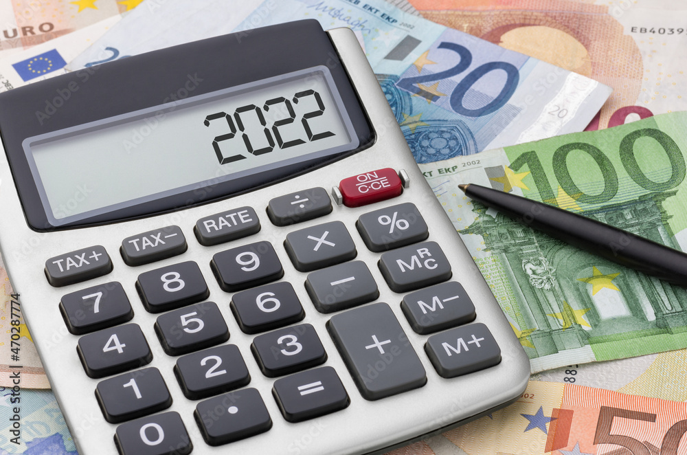 Calculator with money and a pen - 2022