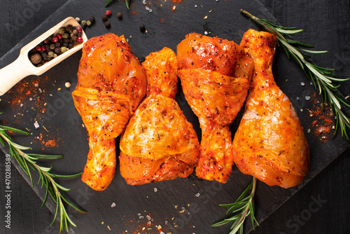 Cooking chicken drumsticks.Raw chicken legs in a marinade with rosemary and pepper.Raw chicken legs. Delicious marinated chicken legs .