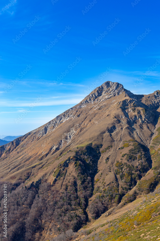 Mountain autumn landscape in the Caucasus mountains. Rosa Peak and Roza Khutor are alpine ski resorts near Krasnaya Polyana town 
