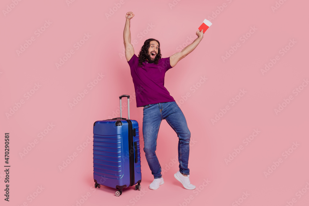 Photo of funny man hold tickets anticipate adventure abroad wear purple t-shirt isolated on pink color background Photo of funny man hold tickets anticipate adventure abroad wear purple t-shirt isolated on pink color background
