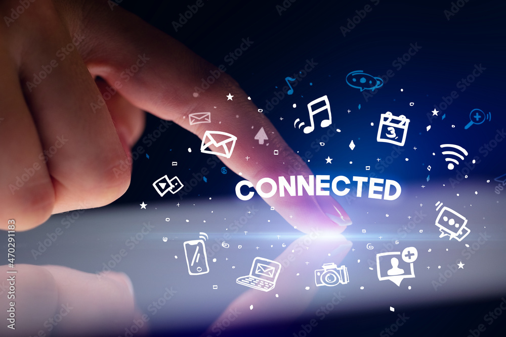 Finger touching tablet with social media icons concept Finger touching tablet with social media icons concept