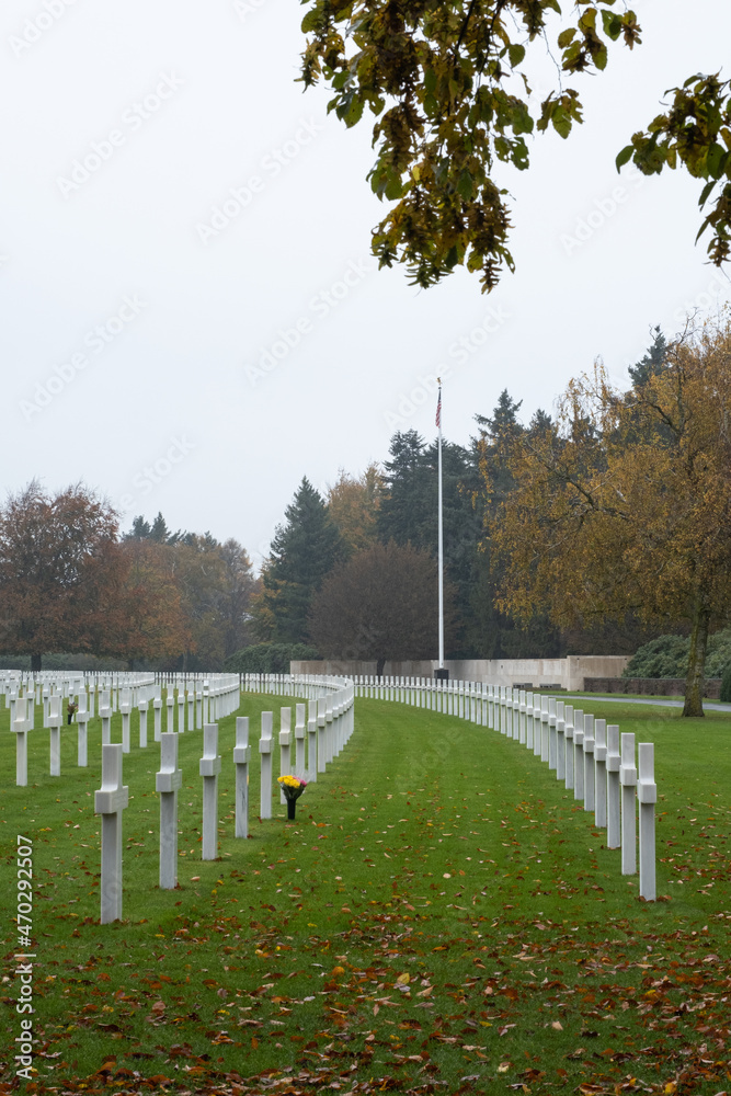 Plombieres, Belgium - November 1, 2021: Henri-Chapelle American Cemetery and Memorial. Many of the burial are from  Ardennes winter offensive (Battle of the Bulge). Autumn rainy day. Selective focus.
