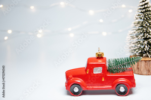 Christmas and New Year background with a red christmas truck and christmas lights on a warm background