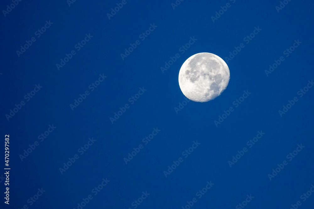 Moon in the waning gibbous phase with blu sky in October Moon in the waning gibbous phase with blu sky in October