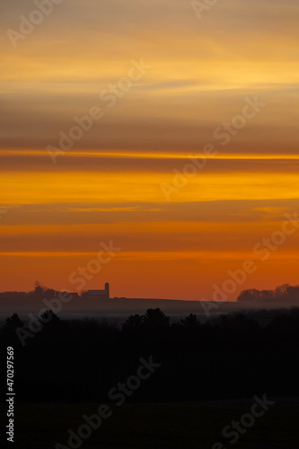 Colorful Wisconsin sunset with silhouette of farm in November