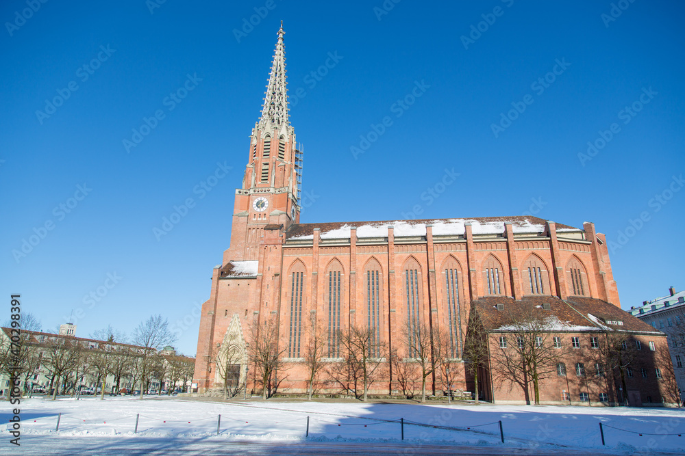 The catholic church Mariahilf in the district Au with its bricks facade and clock tower, new gothic architectural style in Munich, Bavaria, Germany in winter on a sunny day