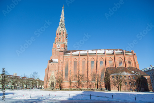 The catholic church Mariahilf in the district Au with its bricks facade and clock tower, new gothic architectural style in Munich, Bavaria, Germany in winter on a sunny day photo