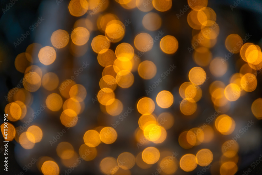 Christmas golden bokeh lights and xmas decoration. Beautiful lights on dark background. Bokeh effect. 