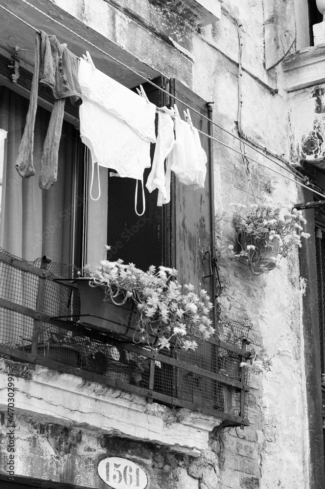 clothes underwear hanging in the window drying old building