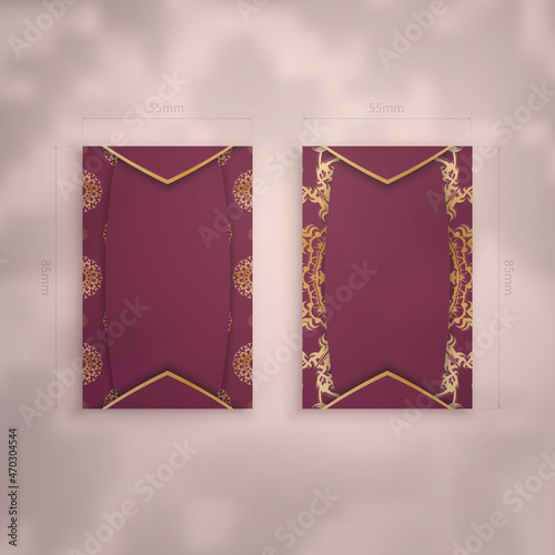 Burgundy business card template with vintage gold pattern for your contacts. photo